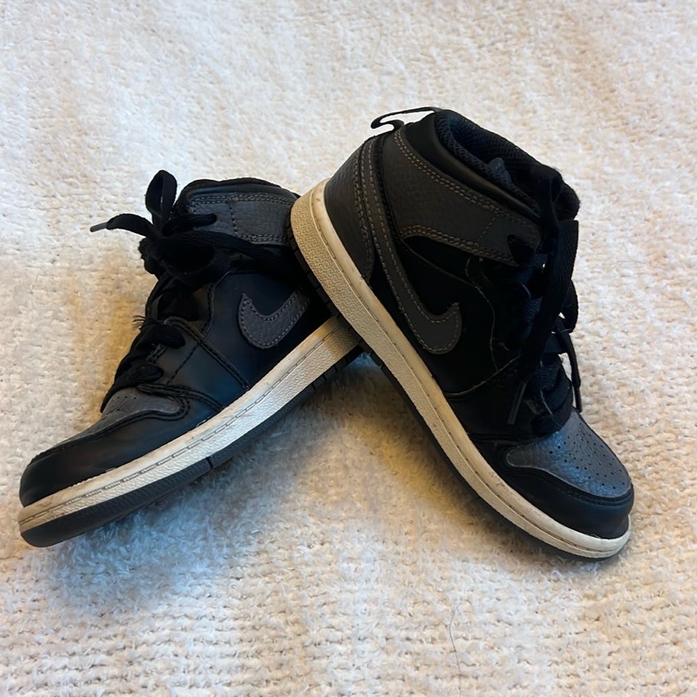 Black and grey children’s Jordan’s size 12C.